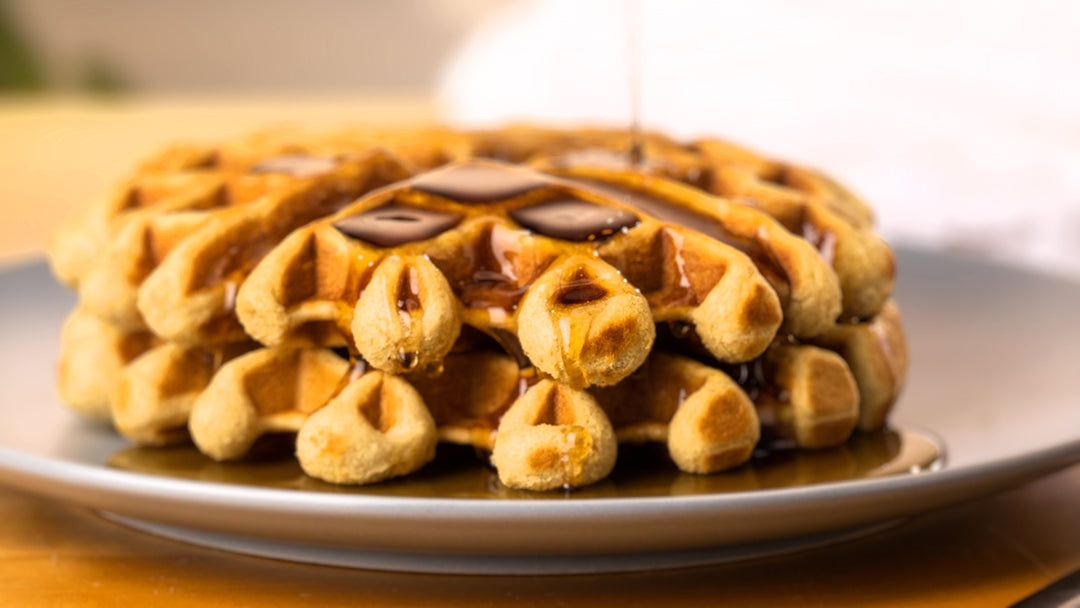 Belgian waffles cooked to perfection with a generous pour of Carman Brook Farm maple syrup.