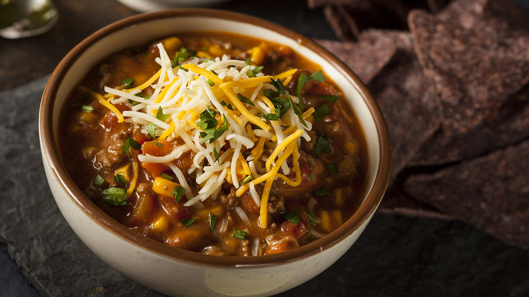 A bowl of my sweet 'n savory chili made with maple syrup and topped with cheese and cilantro.