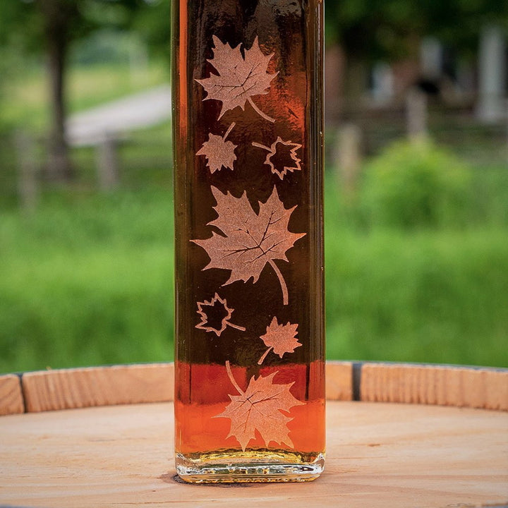 A closer look at the etched maple leaves with amber maple syrup.