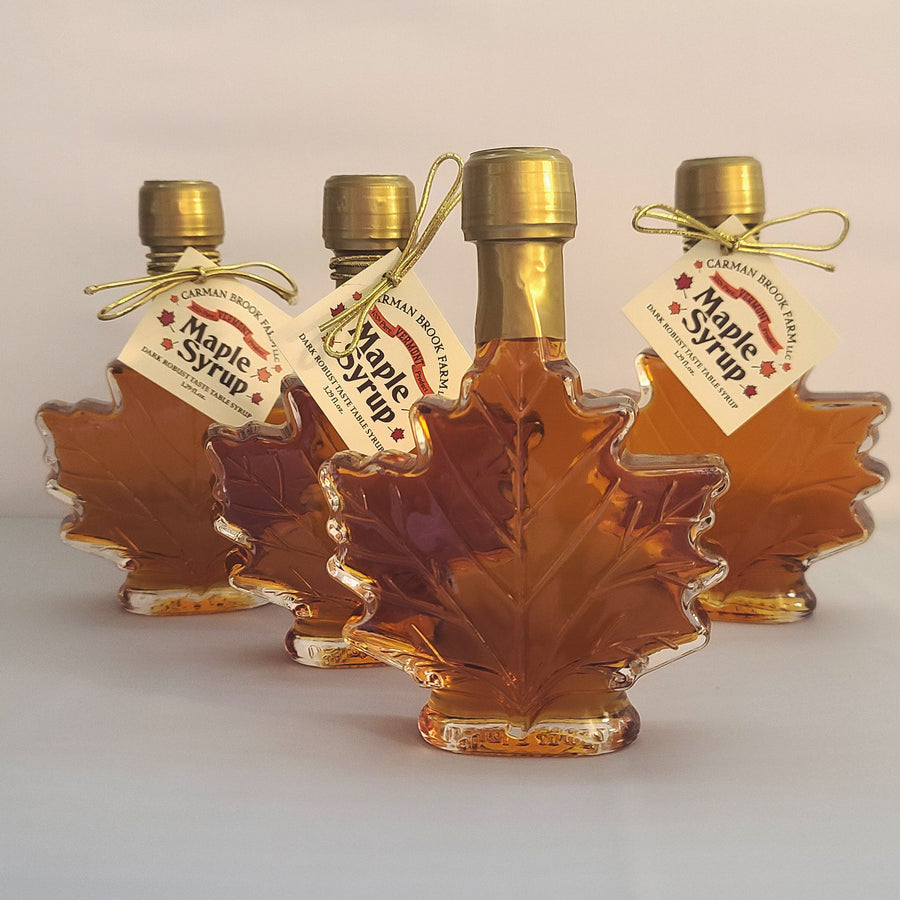 Our medium size maple syrup bottle filled with dark robust maple syrup.